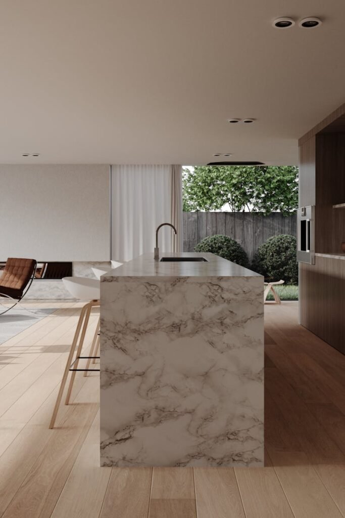 Stylish modern kitchen and living room with marble countertops and open design.